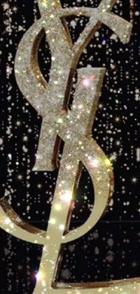 Looking for a stunning and glamorous live wallpaper for your phone? Check out this gold YSL logo on a black background with glittering lights and twinkling stars