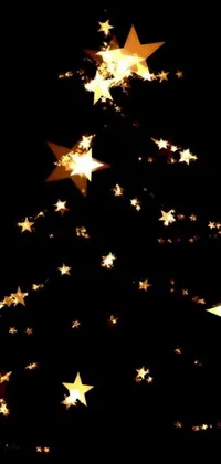 This Christmas live wallpaper showcases a luxurious tree made entirely of golden stars against a backdrop of black