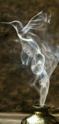 This striking phone live wallpaper features a close-up of a pot emitting whirling smoke against a dramatic black background