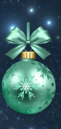 This phone wallpaper showcases a green Christmas ornament adorned with a red bow and snowflakes set against a minimalist ice blue background