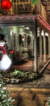 This phone live wallpaper showcases a snowman in front of a house, perfect for winter lovers