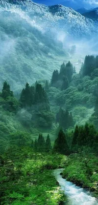 This phone live wallpaper showcases a picturesque river flowing through a lush green valley, nestled amidst a foggy forest and mountainous terrain
