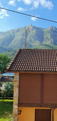 This live wallpaper features a charming French village exterior with a beautiful mountain backdrop