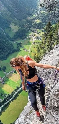 This phone live wallpaper depicts a woman climbing a mountain wearing a harness