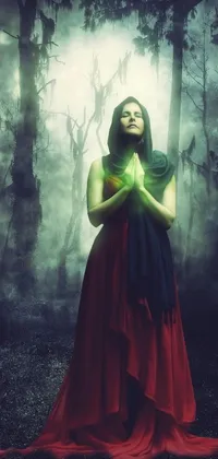 This is a stunning live wallpaper for your phone featuring a digital art of a woman in a red dress standing in a forest