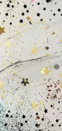 Looking for a unique live wallpaper for your phone? Check out this stunning option that captures a close-up, microscopic view of confetti and stars on a tabletop