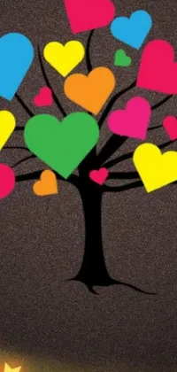 This live wallpaper features a vibrant, colorful tree adorned with plenty of hearts on its branches, set against a background primarily colored in rich brown tones