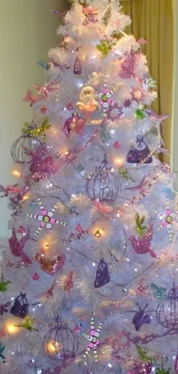 This live wallpaper features a stunning white Christmas tree adorned with pink and purple decorations