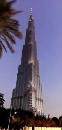 This live wallpaper showcases a mesmerizing water fountain and towering building in Dubai, captured in 3 6 0