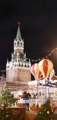 The Christmas Market Live Wallpaper depicts a stunning holiday-themed scene featuring a clock tower in the background