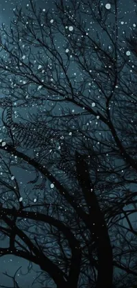 This stunning phone live wallpaper showcases an exquisite digital art of a full moon and a tree, set against a backdrop of falling snow