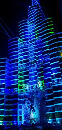This dynamic phone live wallpaper showcases a tall and gleaming building with breathtaking blue and green lights
