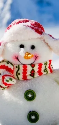 The winter-themed phone live wallpaper depicts a close-up view of a friendly snowman wearing a cozy scarf