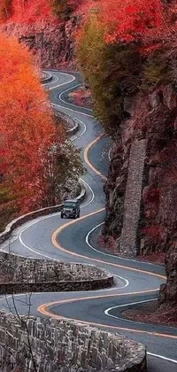 Transform your phone's home screen with this stunning live wallpaper featuring a car driving through a winding mountain road