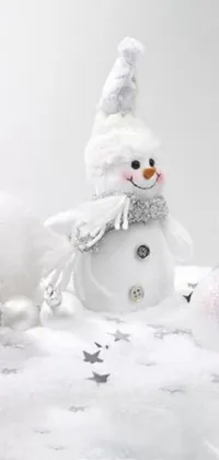This live wallpaper features two snowmen sitting on snowy ground surrounded by glittering silver ornaments
