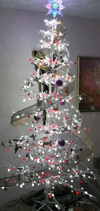 This Christmas themed Live Wallpaper features a beautifully decorated tree made of shiny white metal in a cozy living room setting