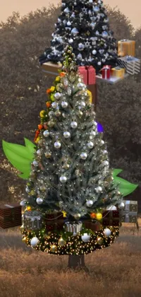 This Christmas-themed live wallpaper features a decorated tree standing tall in a snowy field with gifts underneath
