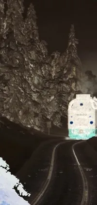 This phone live wallpaper depicts a train journeying through a forest on train tracks, against a dark cave
