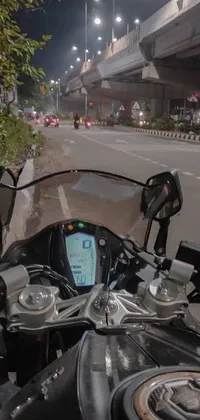 This live wallpaper for your phone features a sleek motorcycle parked on the side of an Indian street