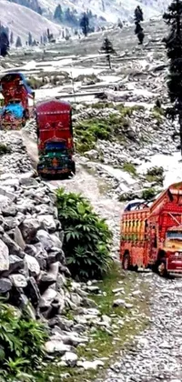 This dynamic phone live wallpaper features a group of trucks driving down a scenic dirt road, surrounded by the stunning beauty of the Himalayan mountains