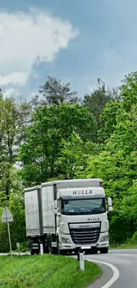 Looking for a dynamic live wallpaper for your phone? Look no further than this incredible scene of a truck driving through a forest! With stunning trees and a weathered sign in the foreground, this wallpaper is perfect for those who love nature and adventure