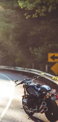 This dynamic phone live wallpaper features a digital art image of a motorcycle parked on the side of the road, with a stunning sunbeam background