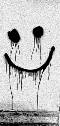 This phone live wallpaper features a black and white photo of a smiley face drawn on the side of a building