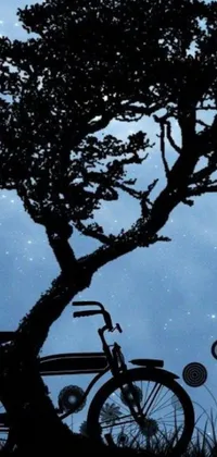 This live wallpaper for your phone showcases a serene scene of a figure perched on a bench located beneath a towering tree