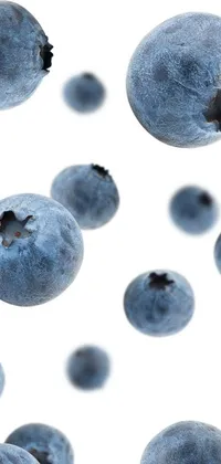 This vibrant wallpaper features a bunch of blueberries in flight captured in high resolution