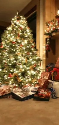 This Christmas-themed phone live wallpaper features a fully decorated living room with an animated and sparkling Christmas tree, accompanied by neatly wrapped presents around the base of the tree