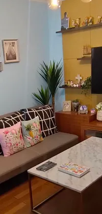 This phone live wallpaper features a cozy living room filled with furniture and a flat screen TV showing a beautiful nature scene