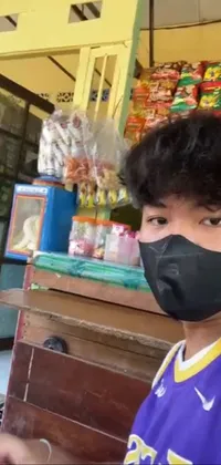 Get the latest mobile live wallpaper from Kanbun Master on Instagram! This unique wallpaper features a man wearing a face mask in front of a store, providing a timely reminder of the importance of staying safe during the pandemic