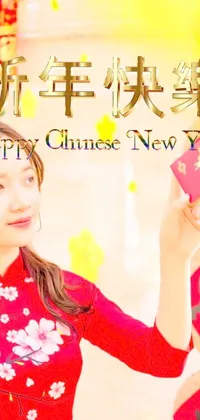This exquisite phone live wallpaper depicts a woman sporting a scarlet dress displaying a Chinese New Year card