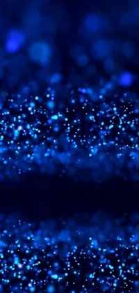 Experience an enchanting digital art display right on your phone's wallpaper! This mesmerizing live wallpaper features close-up shots of stunning blue glitter spread across a black surface