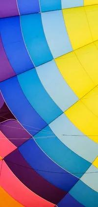This phone wallpaper showcases the vibrant interior of a hot air balloon, designed with a stunning display of colors and geometric shapes