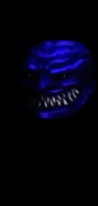 This phone live wallpaper is a creepy close-up of a face in the dark, featuring a demon-like creature with a black, blue, and purple gelatinous texture