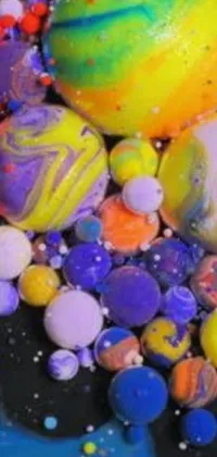 Bring the galaxy alive on your phone screen with this magnificent live wallpaper! Featuring a stunning pile of colorful marbles set against a blue plate, and backed by a striking galactic vista, you'll feel transported to another world