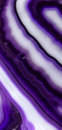 This live wallpaper showcases a stunning macro close-up photograph of a purple and white marble with intricate patterns and swirls