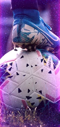 This live phone wallpaper features a vibrant digital art of a person standing on a soccer ball