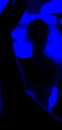 This phone live wallpaper showcases the essence of cold, blue light with a close-up view of an individual holding a tennis racquet against the backdrop of a night club