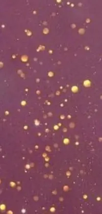 This phone live wallpaper features floating bubbles on a purple surface with microphotography of a red sky