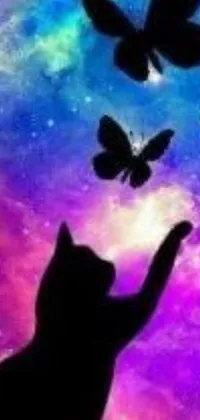This phone live wallpaper depicts a playful black cat reaching towards colorful butterflies in a cosmic purple space background