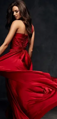 This live phone wallpaper features a beautiful woman in a red dress posing for a photo