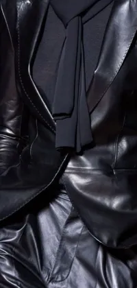 This phone live wallpaper showcases a close-up of a person in a classic suit and tie, accompanied by a skintight leather coat and jacket