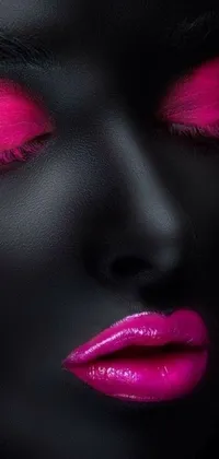 This phone live wallpaper showcases an enigmatic woman's face, featuring vibrant pink eyes and black glossy lips against an all-black matte accents