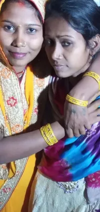 This stunning phone live wallpaper showcases traditional Indian culture with two women standing side by side
