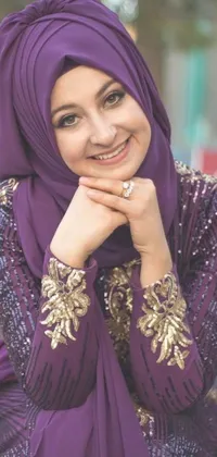 This phone live wallpaper showcases a gorgeous woman wearing a purple hijab in a stunning pose