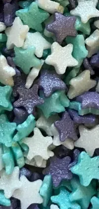 This mesmerizing phone live wallpaper features a pile of stars in blue, green, and white