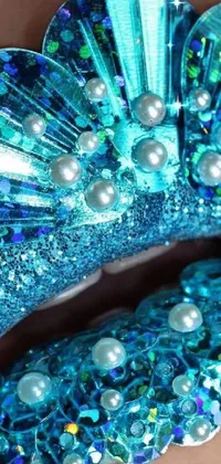This phone live wallpaper showcases a close-up of glittery blue lips adorned with pearls, perfect for those who love mermaid-inspired designs