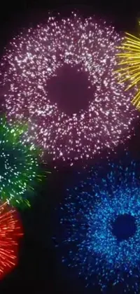 This phone live wallpaper showcases a stunning display of colorful fireworks exploding into the night sky